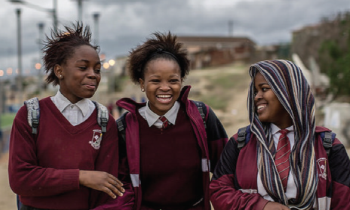 Three African school girls laughing